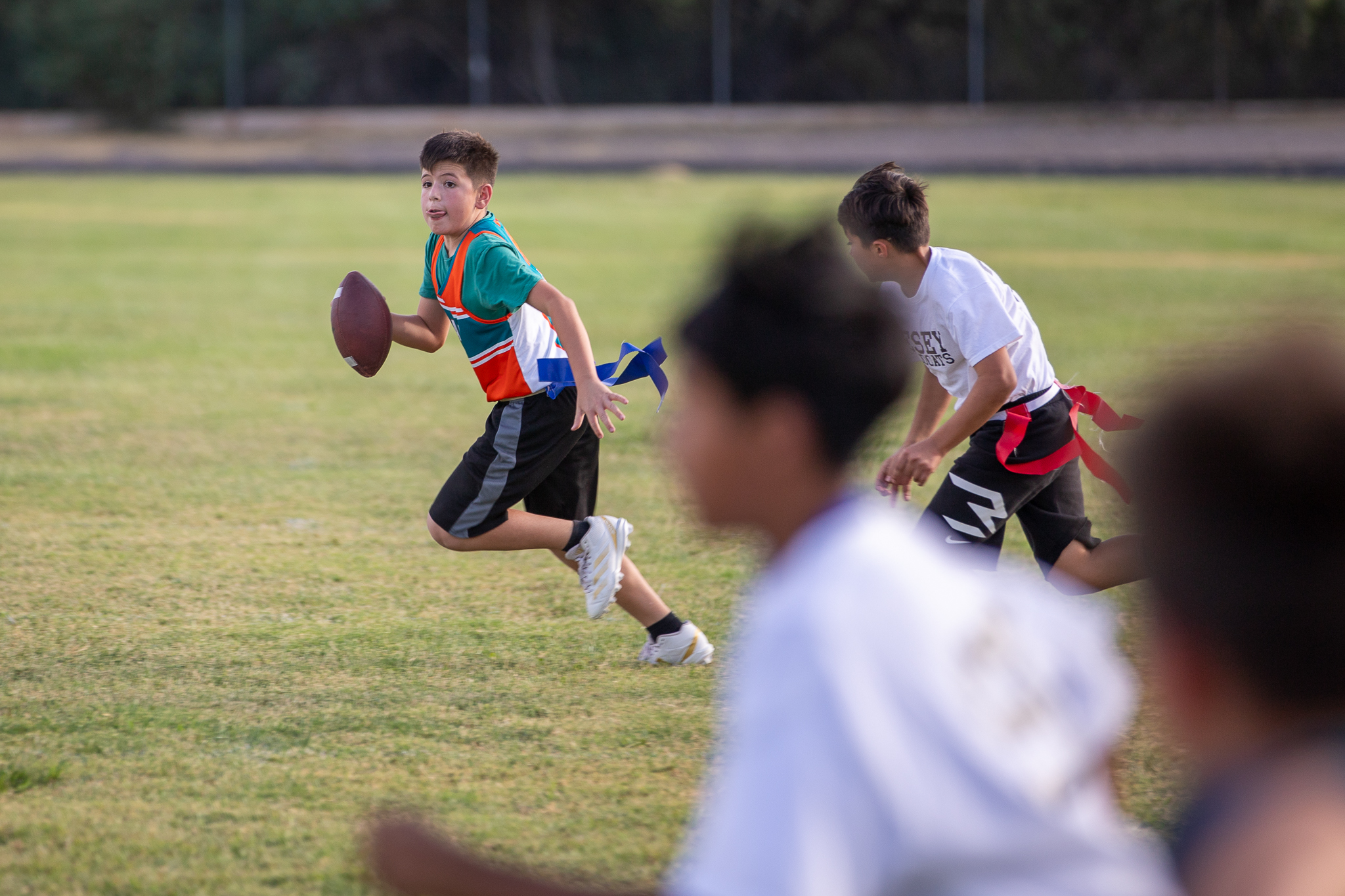 A Gale player holds the football while running away from the Vesey players