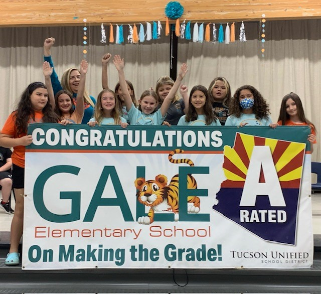 Students and Staff holding Grade A banner for GALE.